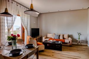 a living room with a couch and a table at Great Alexander Suites in Sarandë