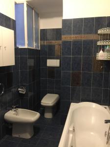 La salle de bains est pourvue de toilettes, d'une baignoire et d'un lavabo. dans l'établissement PARVA DOMUS, à Sanremo