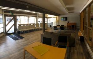 a large room with couches and tables and chairs at Kesäaitat in Ähtäri