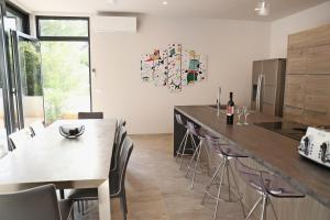a kitchen with a counter and a table and chairs at Seaside villa at Prizba in Prizba