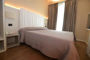 Posteľ alebo postele v izbe v ubytovaní Hotel Enrichetta