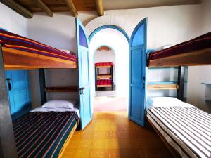 two beds in a room with two bunk beds at Hostel Once Once in Villa de Leyva