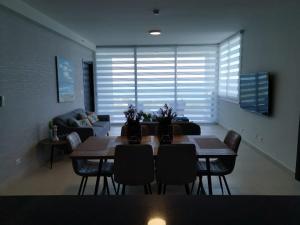 a living room with a table and chairs and a couch at Ocean 3, Playa Blanca in Río Hato