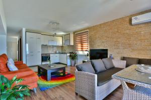 a living room with a couch and a table at Apartments Kentera LUX in Sveti Stefan
