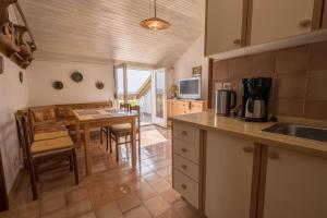 a kitchen and dining room with a table and a dining room at Apartments Fina in Crikvenica
