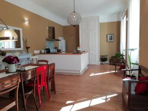 a kitchen and dining room with a table and chairs at Domaine de la Célarié in Mouzieys-Teulet