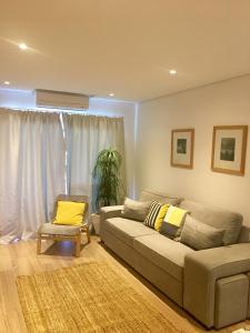 a living room with a couch and a chair at Apartamento Vilamoura Marina in Vilamoura