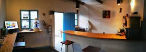 a kitchen with a bar in the middle of a room at Hostel Once Once in Villa de Leyva