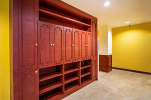a closet with wooden lockers in a room at Scala Hostel in Bangkok