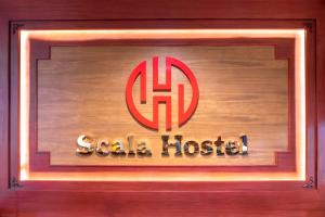 a sign for a gala hosier at Scala Hostel in Bangkok