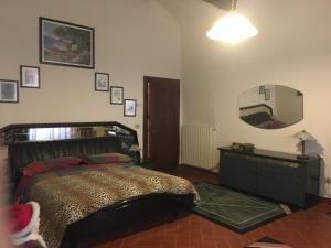 ein Schlafzimmer mit einem Bett und einem großen Spiegel in der Unterkunft Al Borgo in Sansepolcro