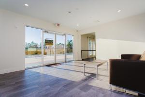 an empty room with a table and large windows at Scottish Inn & Suites - Atascocita in Humble