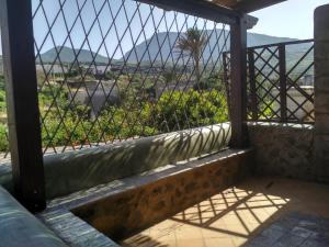 a view from the balcony of a house with a fence at i dammusi di Egle in Pantelleria