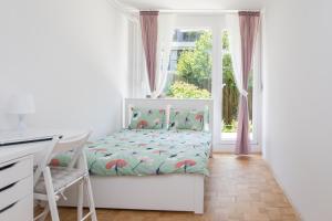 a small bedroom with a bed and a window at Family Apartment with Garden in Ljubljana