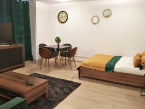 a bedroom with a bed and a table and chairs at Downtown Studio in Zielona Góra