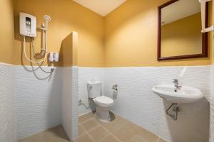 a bathroom with a toilet and a sink at Scala Hostel in Bangkok