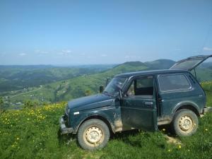 a green jeep parked on top of a hill at Сafe Gorets Hotel in Krivorovnya
