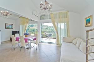 a living room with a couch and a table at Island Hvar Seaside Villa Levanda with Beach, Pool & Seaview in Hvar