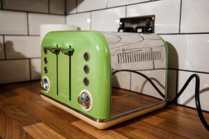 a green and white toaster sitting on a counter at Picturesque Village House in Aghnablaney