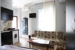 a living room with a couch and a table at Apartment DURU in Batumi