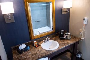
a bathroom with a sink and a mirror at Carson Valley Inn in Minden
