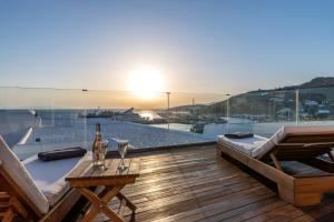 a balcony with a table and a view of the water at Avra Mykonos in Tourlos