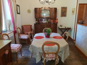a dining room with a table with chairs and a tv at Villa Les Palmiers in Wimereux