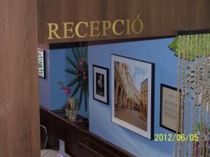 a room with a blue wall with pictures on it at Palma Panzio in Fót