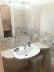 a bathroom with a sink and a mirror at Casa Melograno in Bernalda