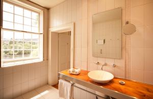 a bathroom with a sink and a mirror at The Woodbridge Tasmania in New Norfolk