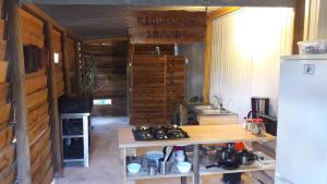 a kitchen with a counter and a stove and a refrigerator at Sintra Vintage Tent in Sintra