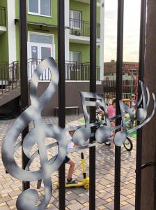une sculpture métallique d'un signe dollar devant un bâtiment dans l'établissement Апарт-отель "МАЭСТРО", à Anapa