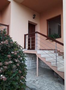 a building with stairs and a balcony with flowers at Ladislav in Spišské Vlachy