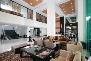 a living room filled with furniture and a large window at Kantary Hotel Kabinburi in Kabin Buri