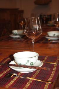 a table with a bowl and a glass of wine at Thai Binh Garden in Thái Bình
