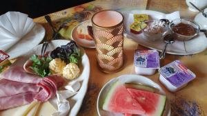 a wooden table with plates of food on it at Landgasthof Pension Schützenhaus in Dürrhennersdorf