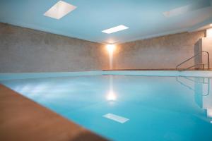 a swimming pool with a blue light on the ceiling at La Villa in Salò