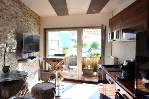 a kitchen with a large glass door to a balcony at Apartments Am Werdersee in Bremen