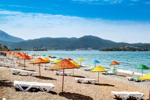 a beach filled with lots of colorful umbrellas at Eyna Hotel in Fethiye
