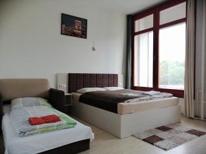 Posteľ alebo postele v izbe v ubytovaní Zoom-Budapest Apartments