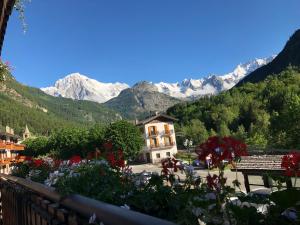 a scenic view of a village with a mountain range at Hotel Edelweiss in Pré-Saint-Didier