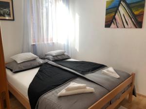 ein Bett in einem Schlafzimmer mit zwei weißen Handtüchern darauf in der Unterkunft VILLA DIVNA in Labin