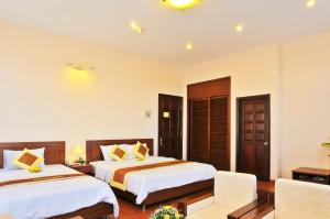 Postel nebo postele na pokoji v ubytování Ky Hoa Hotel Da Lat