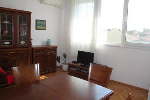 a dining room with a table and a television at Sunny Cozy Flat in the Centre, close to beach, 4 rooms, 105sqm in Varna City