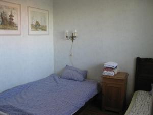 a bedroom with a bed and a nightstand with two candles at Private Apartment in Tallin (Pelguranna) in Tallinn