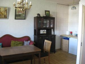 a living room with a table and a kitchen at Private Apartment in Tallin (Pelguranna) in Tallinn