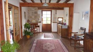 a hallway with a door and a table and chairs at Au clair du soleil in Saint-Juire-Champgillon