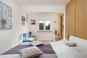 a bedroom with two beds and a window at Vila Tatjana in Klenovica