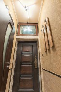 a hallway with a door with a window above it at Deluxe Studios City Center in Burgas City