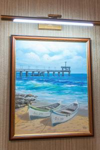 a painting of two boats on the beach with a pier at Deluxe Studios City Center in Burgas City